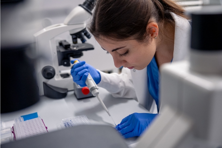 NSU student researcher with pipette