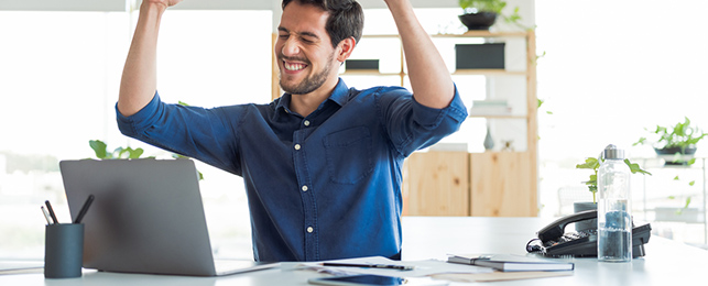 young man celebrating in office