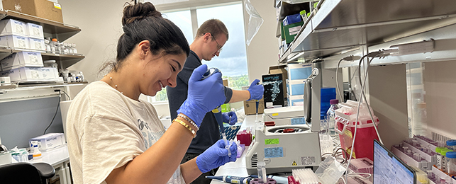 Two genomic researchers working in a lab