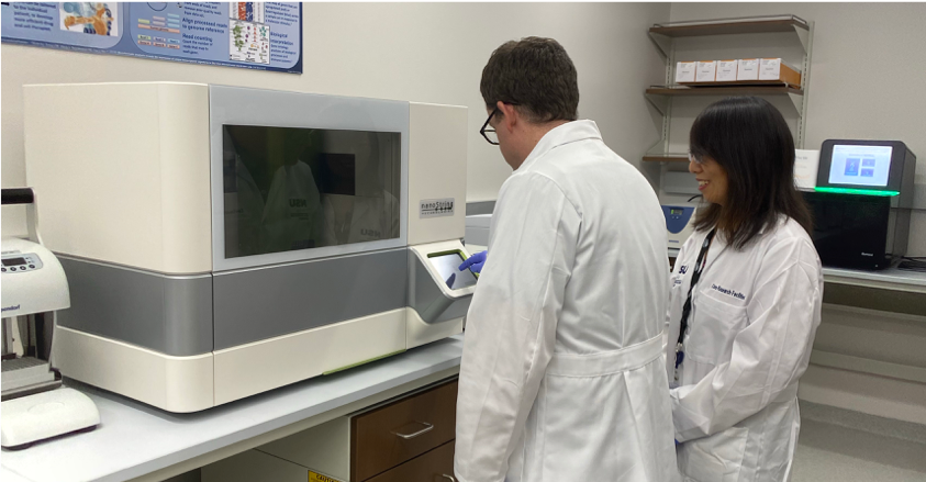 Genomics Technicians using equipment