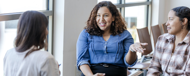 Two students in a mediation session with a mediator